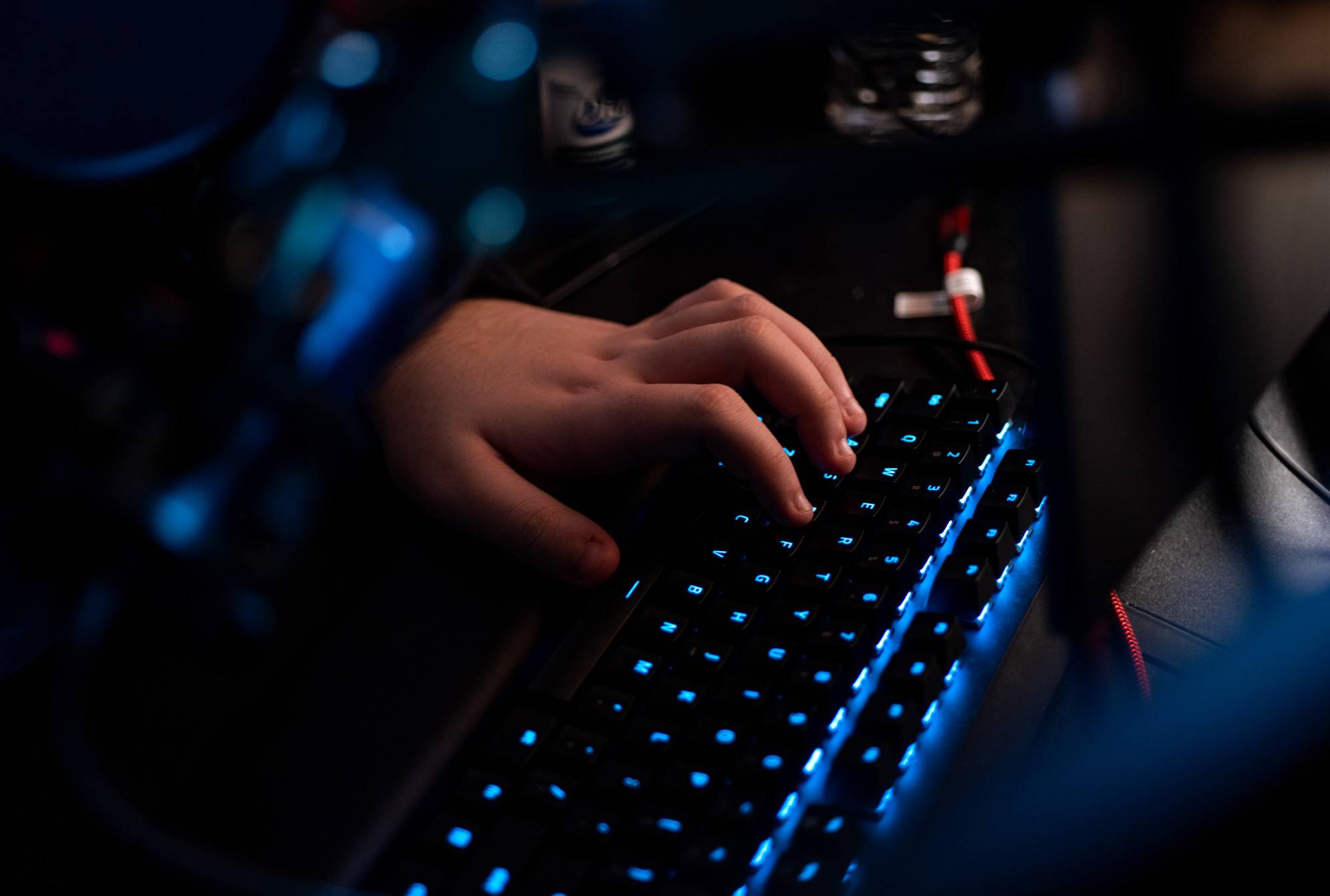 Hands over a keyboard with keys lit up